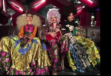 Three performers in expressive makeup and colourful creative costumes